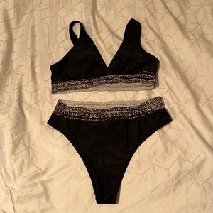 Black and leopard print swim suit. New. Never worn. Large